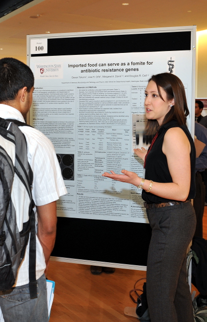 A photo showing a SURCA student presenting her poster